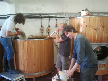 Tom scooping oats, Greg and Stu mash in...